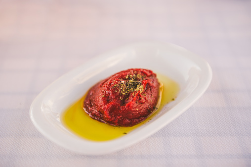 Tomato paste in olive oil as starter in Greek restaurant