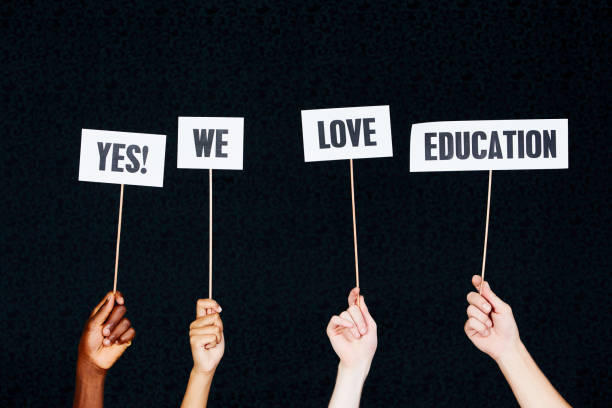 istock Four raised hands hold signs 