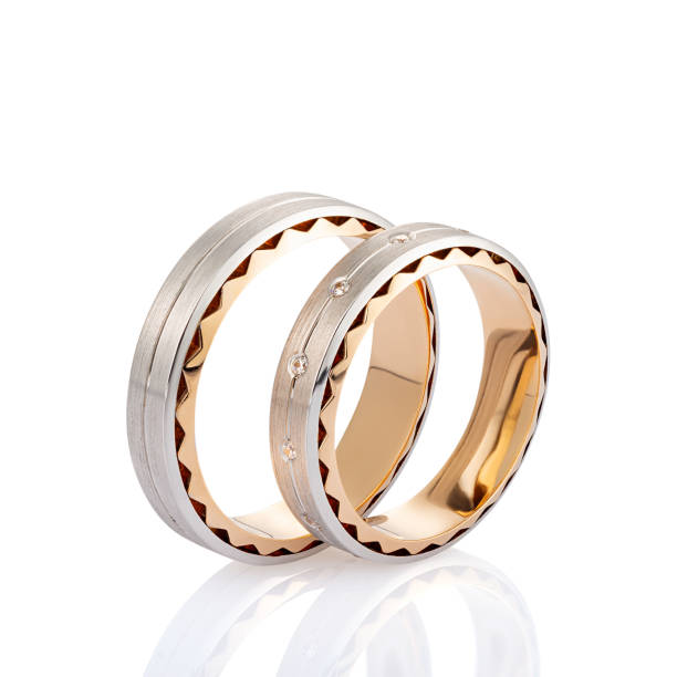 istock Pair of two tone gold wedding ring with matte surface and diamonds isolated on white background 1136770629