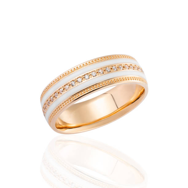 istock Gold ring with white enamel and diamonds isolated on white background 1136770638