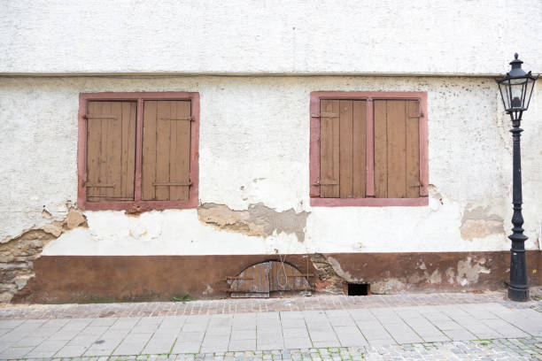 istock Old German front facades with front doors, wooden shutters, windows and plastered walls. 1136770677