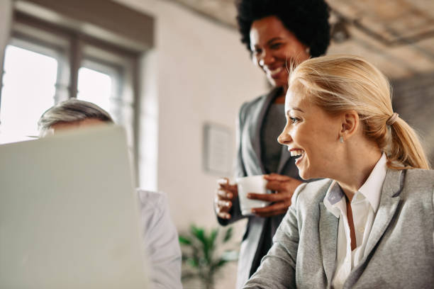 istock Happy businesswoman having fun with her colleagues at work. 1136771355