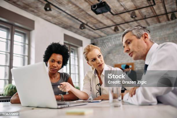 Multiethnic Group Of Business People Working On Laptop During A Meeting Stock Photo - Download Image Now