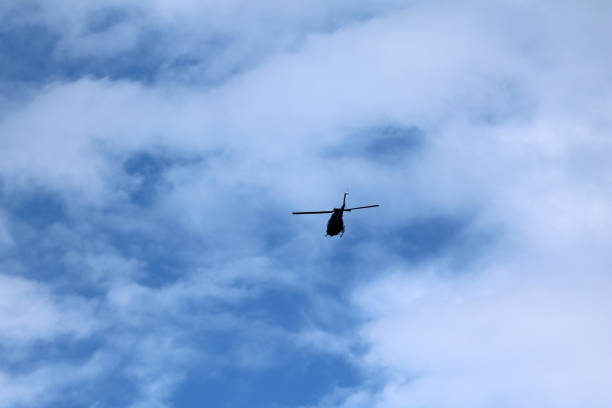 istock black helicopter aircraft during the flight with blue sky 1136773043