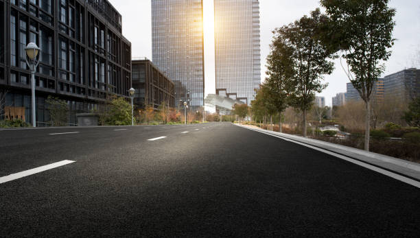 istock Asphalt pavement and modern architecture of city highway 1136773805
