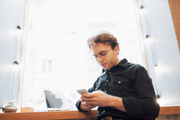 istock Relaxed young professional surfing the Internet on his laptop in a cafe 1136774790
