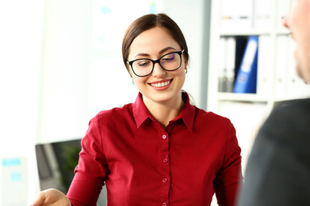 istock Beautiful smiling clerk wearing glasses with silver pen 1136775199