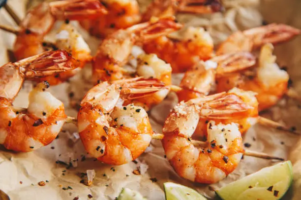 Grilled shrimps on a skewer with seasoning and lime