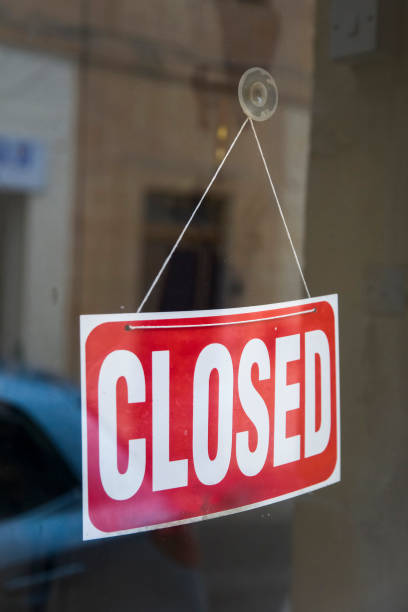 istock Closed sign board on the store window 1136778195