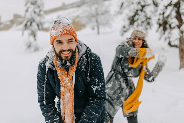 Couple in the snow playing