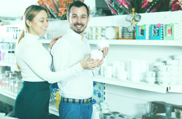 istock Couple choosing new crockery in dinnerware store 1136778327