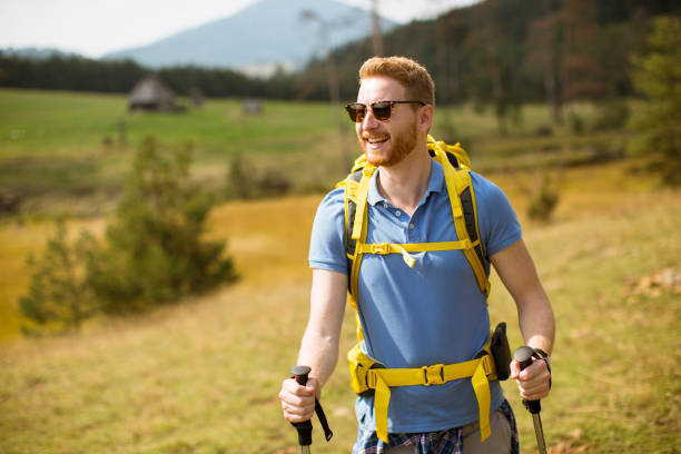 istock Young hiker enjoys a sunny day on the mountain 1136778509