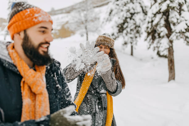 istock Couple in the snow playing 1136778615