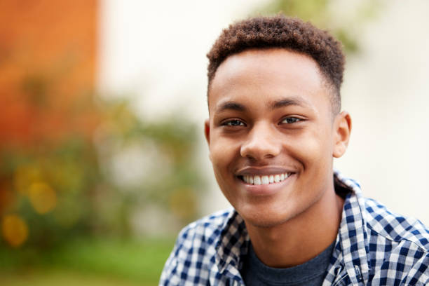 istock Young black man outdoors smiling to camera, close up, head and shoulders 1136779248