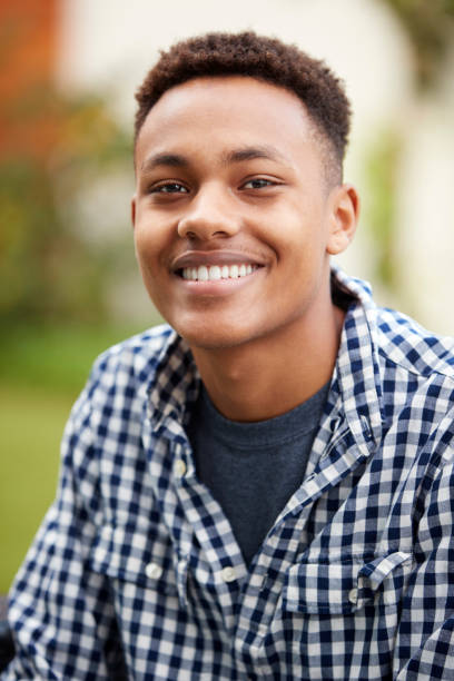 istock Young black man outdoors smiles to camera, close up, vertical 1136779262