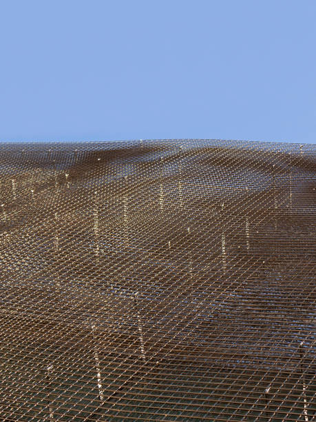 istock Wire mesh steel for skyscraper building under blue sky 1136779430