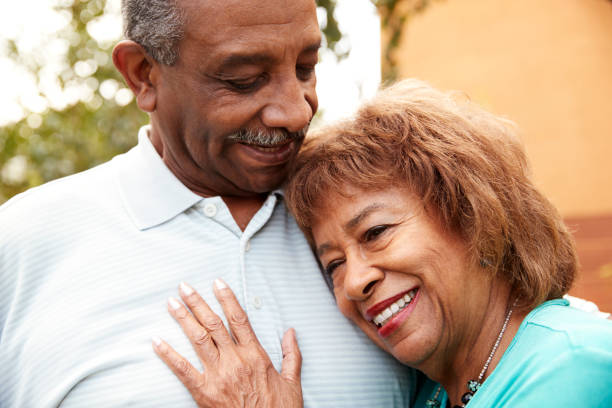 istock Senior black husband and wife embracing outdoors, close up 1136780030