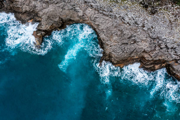 istock Sea waves hitting the rocky shore 1136780936
