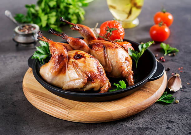 istock Baked quails in pan on a dark background 1136781894
