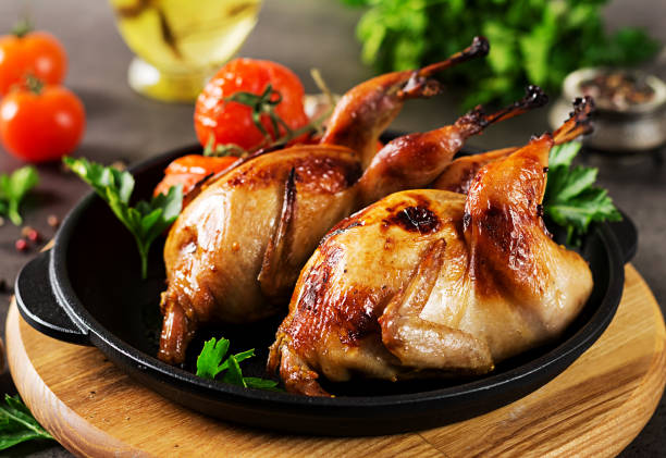 istock Baked quails in pan on a dark background 1136781903