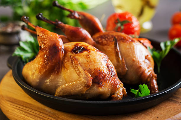 istock Baked quails in pan on a dark background 1136781918
