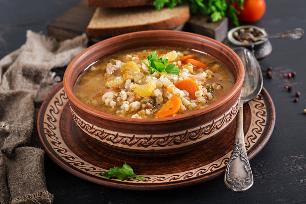istock Barley soup with carrots, tomato, celery and meat on a dark background. 1136782181
