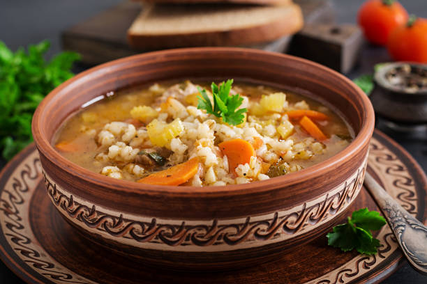 istock Barley soup with carrots, tomato, celery and meat on a dark background. 1136782242