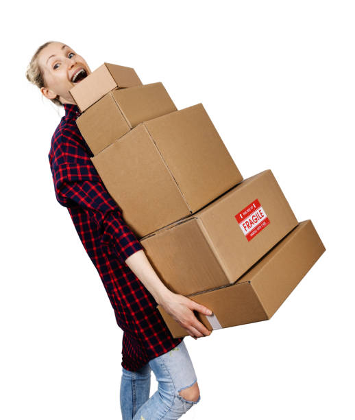 istock young woman carrying stack of heavy cardboard boxes isolated on white 1136784597