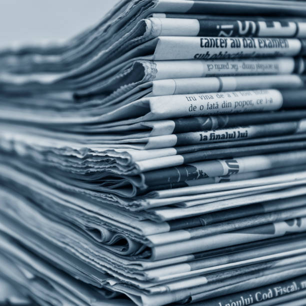 istock Blue monochrome abstract background of newspaper stack 1136785615