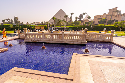 Swimming pool with Cheops pyramid in the background. Pyramids of Giza near Cairo, Egypt. Autumn 2018