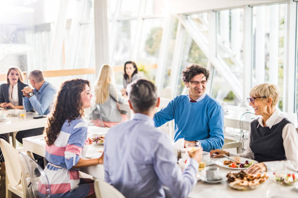 istock Happy business colleagues talking on a lunch break in cafeteria. 1136786115