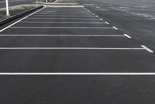 Empty parking lot outdoor with white marking lines. Concept of car traffic.