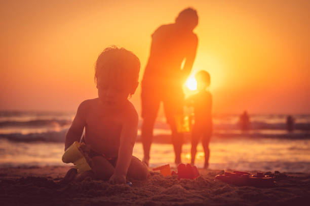 Mother and little baby girl on beach