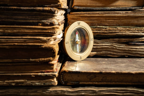 istock Compass On Stack Of Antique Hard Cover Books 1136787810