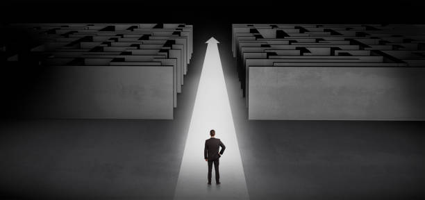 istock Businessman going straight ahead between two mazes 1136787811