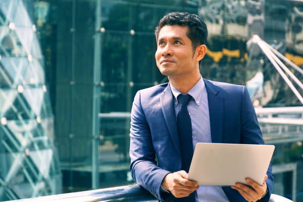 istock Businessman carrying notebooks and thinking 1136788762