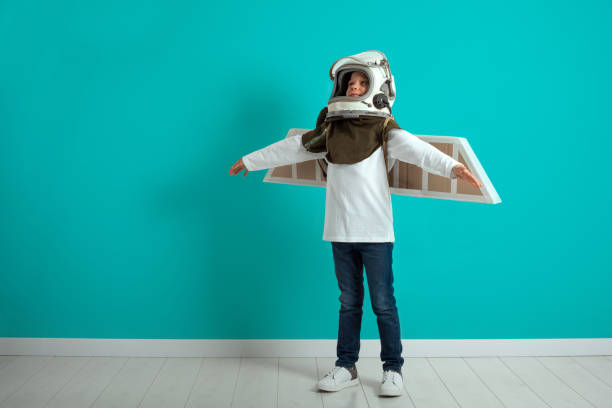 istock Young guy fancies himself donning BY PLANE PILOT HELMET 1136788968