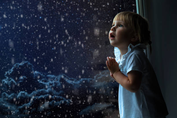 istock the child is looking in the spring window 1136789010