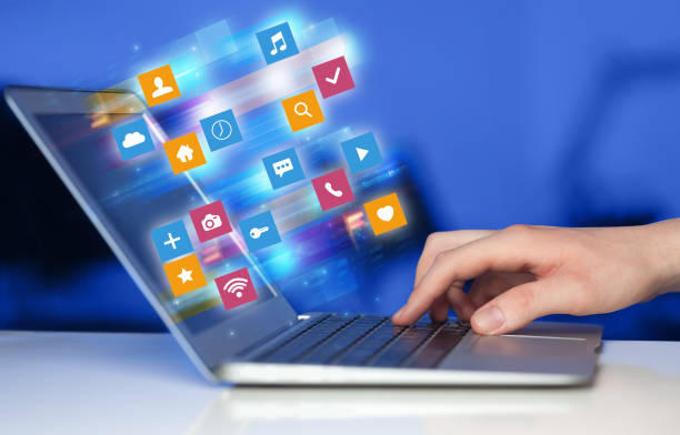 istock Hand using laptop with colorful application icons and symbols concept 1136789043