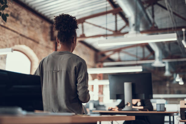 istock Charming afro american girl in gray shirt spending time at work 1136789075