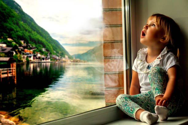 istock the child is looking in the spring window 1136789111
