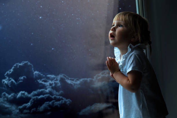 istock the child is looking in the spring window 1136789147