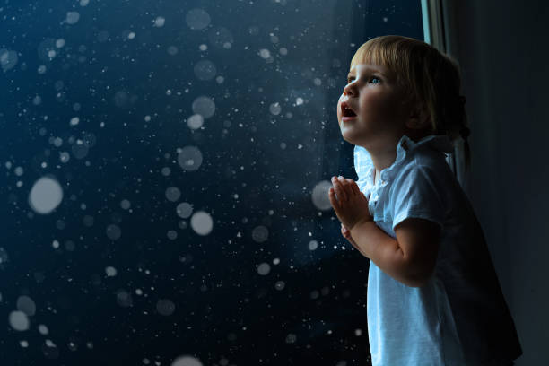 istock the child is looking in the spring window 1136789260