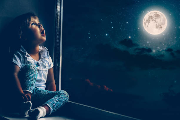 istock the child is looking in the spring window 1136789274