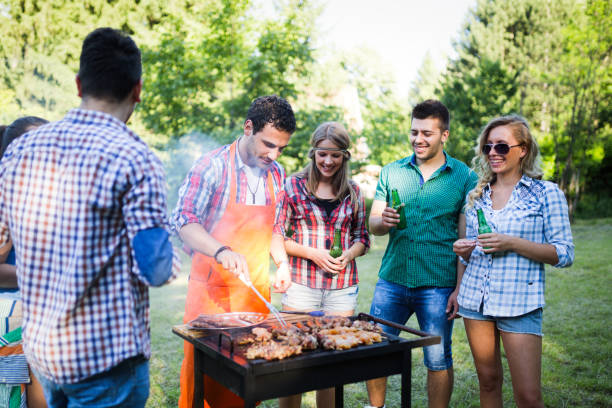 istock Happy students having barbecue on summer day 1136789733