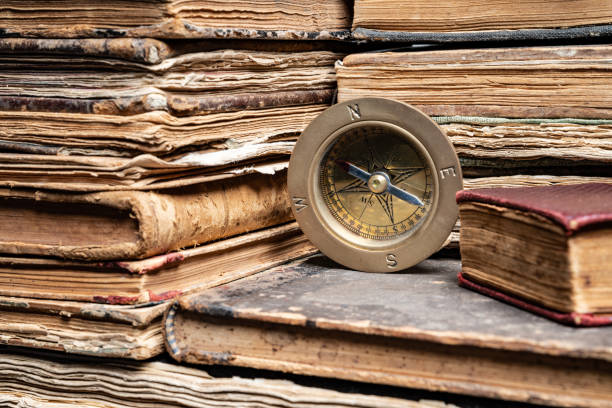 istock Compass On Stack Of Antique Hard Cover Books 1136791000