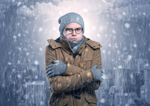 istock Boy freezing in cold weather with city concept 1136791789