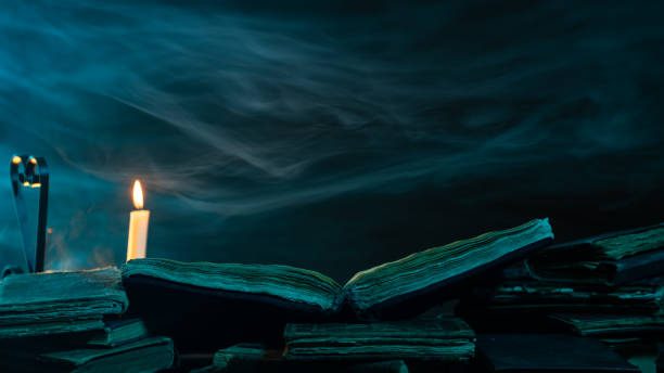 istock Stack Of Antique Books With Candlelight In Dark 1136793459