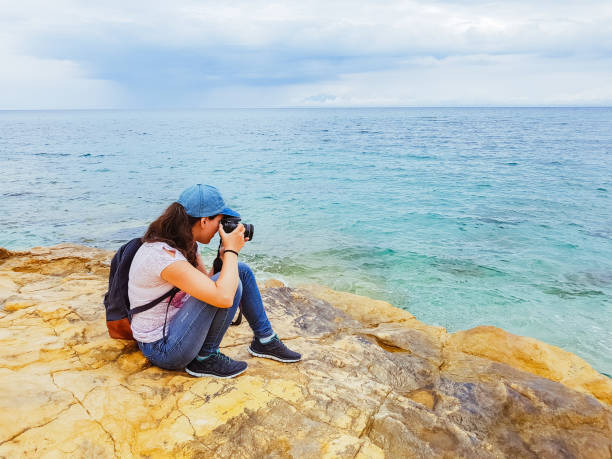 istock Woman making photos at seaside viewpoint 1136793518