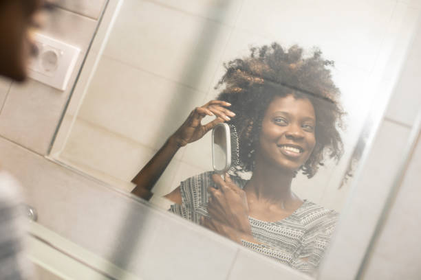 istock Young woman combing her hair 1136793532
